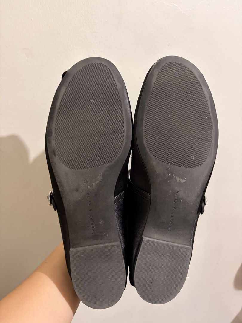 Charles & Keith Black Mary Jane Flats Size 36 (Category: Flats & Sandals) located in Quezon City. Submitted by djmcderay (Listing ID 1470758772, Image 2). Description: - Brand: Charles & Keith - Style: Black satin Mary Jane flats with a charming toe bow and buckled strap - Size: EU 36 / PH 6 - Soles: Flat heels with rubber grip for anti-slip - Condition: Clean insoles with clear branding; light wear on bottom soles - Great for work, casual outing