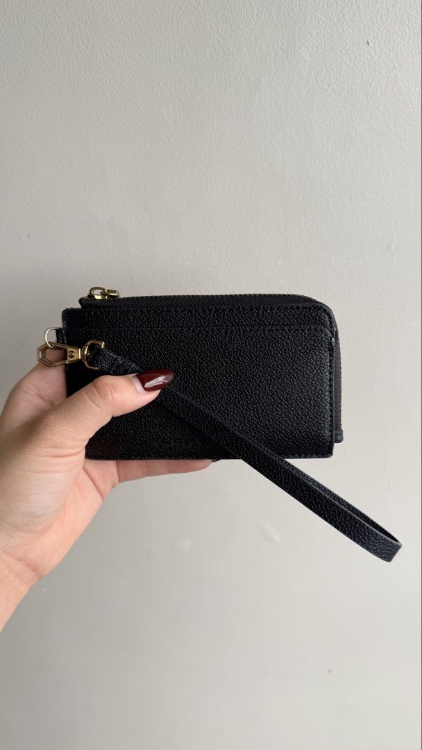 Charles & Keith Black Zip Cardholder with Wristlet Strap (Category: Wallets & Card holders) located in Pasay City. Submitted by maviemavz (Listing ID 1470794741, Image 3). Description: Material: Black pebble-textured faux leather - Secure zippered top compartment for coins/cash, multiple card slots on the back - Removable wristlet strap with gold-tone hardware, original dust bag, and box included - Clean inside and out and still in good condition