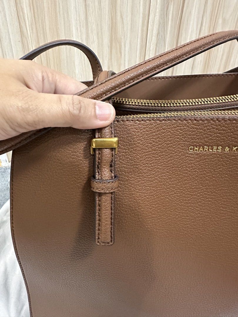 Charles & Keith Brown Tote Bag (Category: Tote Bags) located in Antipolo. Submitted by jloom (Listing ID 1470903994, Image 3). Description: - Brand: Charles & Keith - Color: Brown - Material: Textured leather finish - Hardware: Gold-toned - Bought P5000 at C&K shop in SM megamall lastyr 2025 - Used Trice, with dust bag (I have the paper bag kaso lukot na) - Can send other pic/video for checking -No issue. Papasa sa maarte. -RFS: Need to declutter