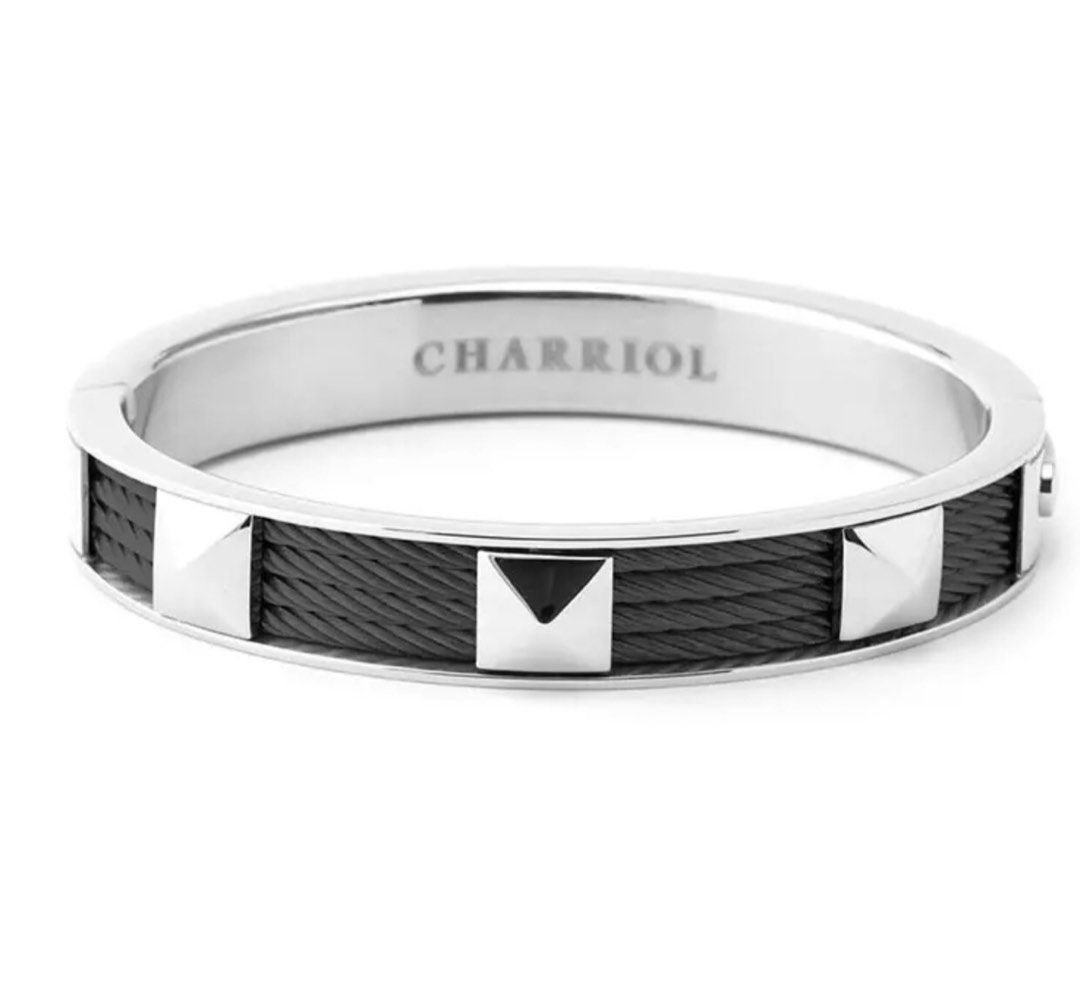 Charriol Black Cable Studded Bangle Bracelet (Category: Jewelry) located in Paranaque City. Submitted by luxthings.etc. (Listing ID 1470838845, Image 3). Description: - Authentic Charriol bangle bracelet - Striking black steel cable design with silver-tone pyramid studs - Stamped with the Charriol brand name on the inner band - Solid steel edges with a smooth interior lining for comfortable wear - Condition: Excellent/Pre-loved -Bought for 25k - 