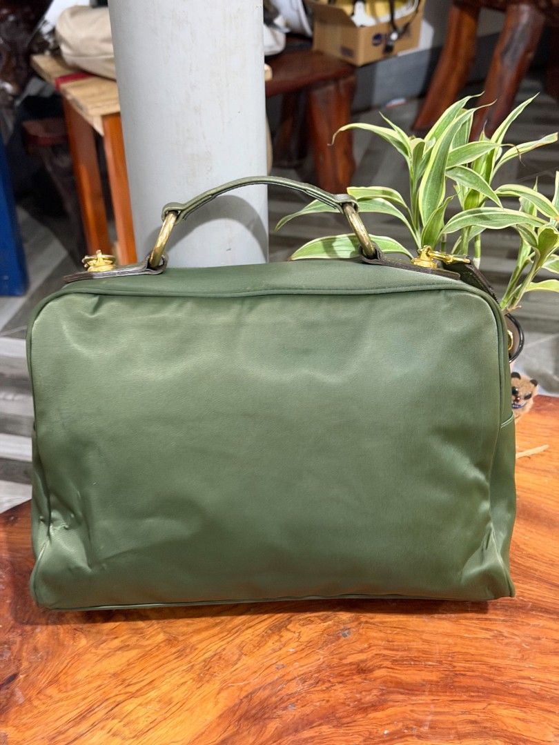 Cheap Chic by Moschino Green Shoulder Bag (Category: Shoulder Bags) located in Baguio. Submitted by ljen2574460 (Listing ID 1470877481, Image 2). Description: - Brand: Cheap Chic by Moschino - Material: Durable green nylon with gold hardware - Details: Adorable heart zipper pull and playful abstract heart interior lining - Versatility: Includes top handles and an adjustable crossbody strap - Storage: Convenient interior zip pocket for essentials 
