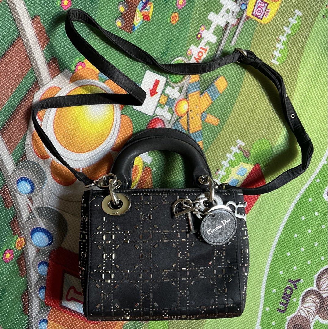 Christian Dior Beaded Lady Dior Bag (Category: Shoulder Bags) located in Lapu Lapu. Submitted by ukaydecebuofficial (Listing ID 1470801294, Image 2). Description: - Brand: Christian Dior - Color: Black with metallic bead embroidery - Pattern: Iconic cannage pattern - Hardware: Silver-tone with signature Dior charms and CD-engraved rings - Strap: Detachable black strap with engraved CD logo - Design: Classic structured top handle - Condition: Exce