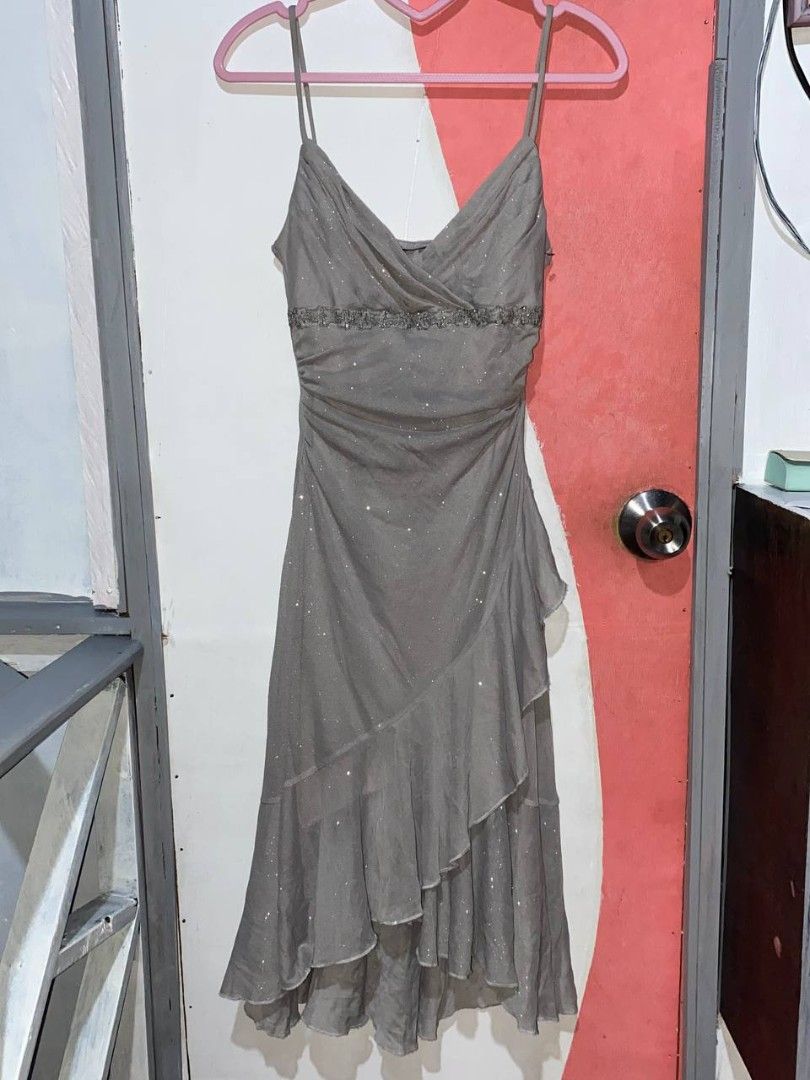 City Triangles Silver Shimmer Ruffle Dress Spaghetti Strap (Category: Dresses) located in Iloilo. Submitted by xya.xoxo28 (Listing ID 1470861891, Image 3). Description: - Brand: City Triangles - Color: Sparkly silver (shimmery fabric that catches the light) - Style: Spaghetti straps, v-neckline, gathered bodice - Hemline: Asymmetrical high-low with ruffled tiers (midi length depending on height) - Condition: Excellent, worn only once for an event
