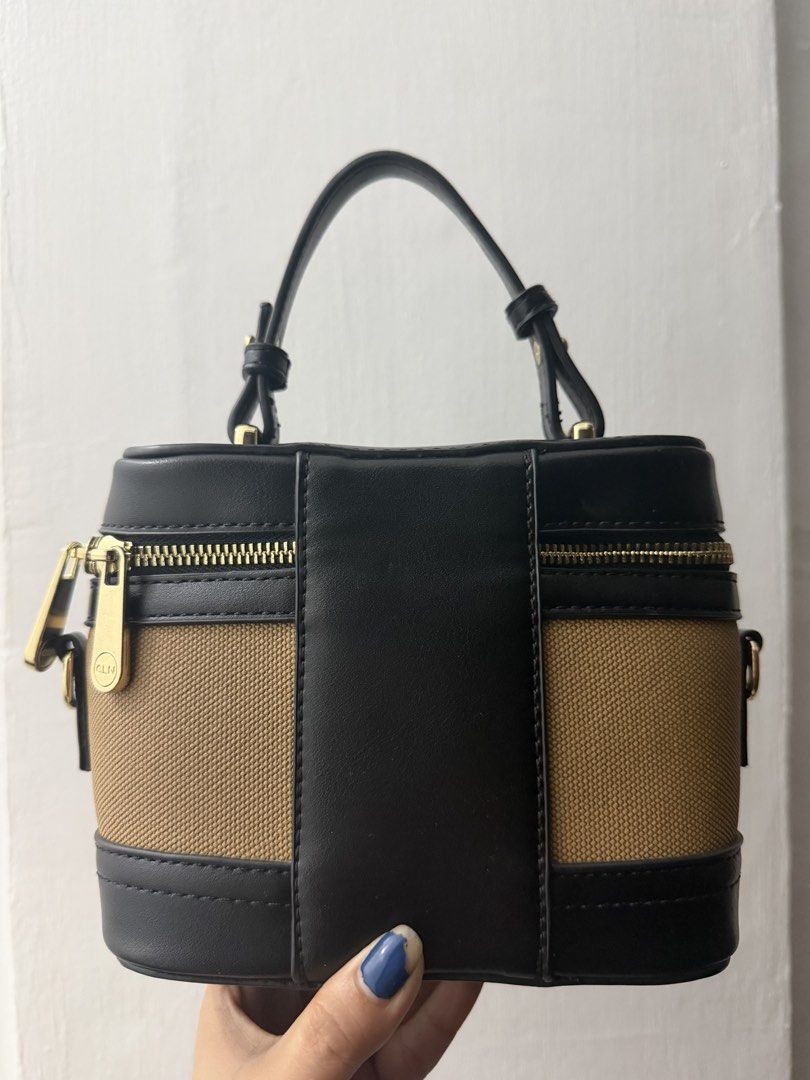 CLN Black and Tan Vanity Bag (Category: Luxury Bags & Wallets) located in Quezon City. Submitted by skyleeeee (Listing ID 1470919174, Image 2). Description: - Brand: CLN - Color: Black and tan - Style: Structured vanity handbag with top handle - Closure: Zip-around - Hardware: Gold-tone - Interior: Printed fabric lining - Extras: Includes matching black detachable shoulder strap and front CLN logo tag MOP: gcash bank transfer Delivery: Same day v