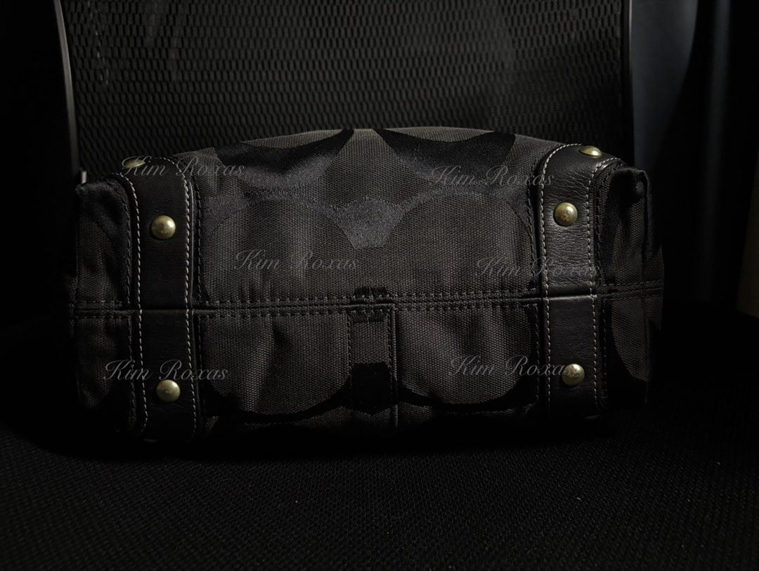 Coach Carly Medium Triple Black (Category: Luxury Bags & Wallets) located in Cavite. Submitted by kimmy.019 (Listing ID 1470754182, Image 2). Description: - Brand: Coach - Material: Signature C jacquard fabric in triple black - Hardware: Brass accents, studs, and multiple metal rings - Design Details: Chic turn-lock details on side gussets - Strap: Adjustable leather shoulder strap with a reinforced center handle pad - Base: Structured bottom wit