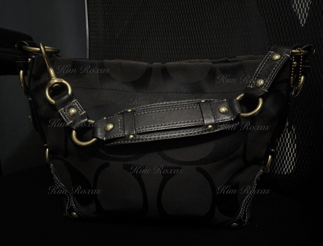 Coach Carly Medium Triple Black (Category: Luxury Bags & Wallets) located in Cavite. Submitted by kimmy.019 (Listing ID 1470754182, Image 1). Description: - Brand: Coach - Material: Signature C jacquard fabric in triple black - Hardware: Brass accents, studs, and multiple metal rings - Design Details: Chic turn-lock details on side gussets - Strap: Adjustable leather shoulder strap with a reinforced center handle pad - Base: Structured bottom wit