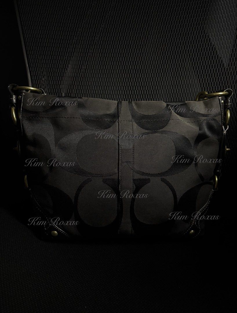 Coach Carly Medium Triple Black (Category: Luxury Bags & Wallets) located in Cavite. Submitted by kimmy.019 (Listing ID 1470754182, Image 3). Description: - Brand: Coach - Material: Signature C jacquard fabric in triple black - Hardware: Brass accents, studs, and multiple metal rings - Design Details: Chic turn-lock details on side gussets - Strap: Adjustable leather shoulder strap with a reinforced center handle pad - Base: Structured bottom wit