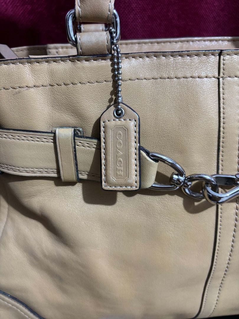 Coach Hampton Leather Tote Bag Tan (Category: Luxury Bags & Wallets) located in Taguig. Submitted by classicurations (Listing ID 1470835142, Image 3). Description: Tan leather tote bag. Dual top handles and silver tone hardware. Front clasp closure with matching belt detail. Includes Coach hangtag. Interior creed patch reads style number A0851-F11200, crafted in China from natural cowhide leather. Fabric lined interior with zip pocket. Shows mino