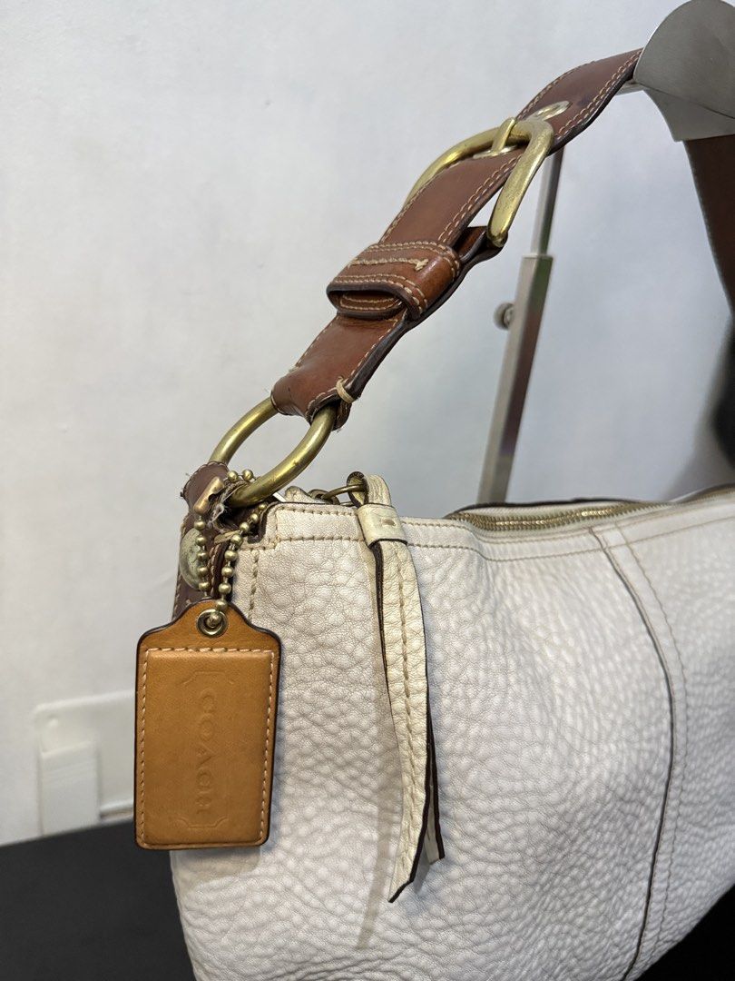 Coach Hobo Shoulder Bag (Category: Luxury Bags & Wallets) located in Cainta. Submitted by angellyy_ (Listing ID 1470878646, Image 2). Description: Coach Hobo Pebbled Leather Semi Med Size Flaws - Dryness on leather, some fading on hardware, rubber lining on strap connectors Condition- 7.5/10 Very vintage look No flaws on interior .
