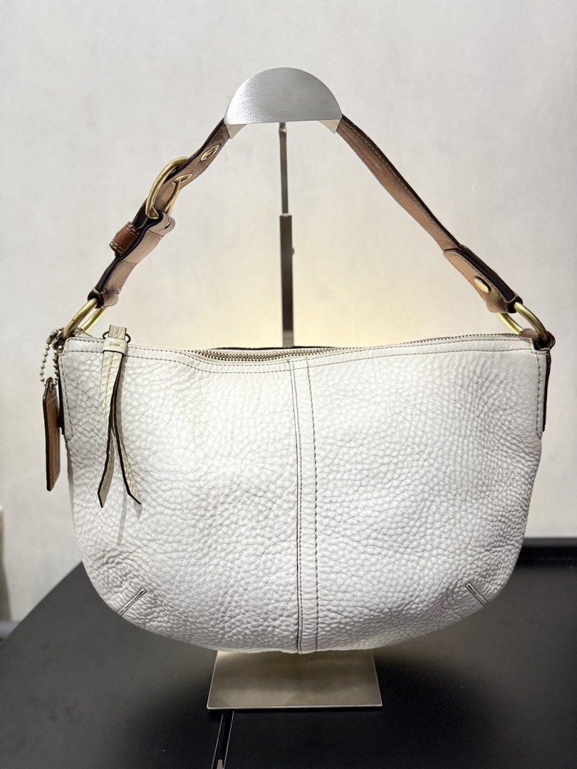 Coach Hobo Shoulder Bag (Category: Luxury Bags & Wallets) located in Cainta. Submitted by angellyy_ (Listing ID 1470878646, Image 1). Description: Coach Hobo Pebbled Leather Semi Med Size Flaws - Dryness on leather, some fading on hardware, rubber lining on strap connectors Condition- 7.5/10 Very vintage look No flaws on interior .