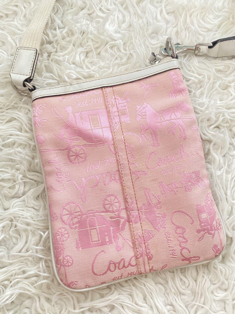 Coach Horse and Carriage Canvas (Category: Luxury Bags & Wallets) located in Tabaco. Submitted by camila_dp (Listing ID 1470800712, Image 3). Description: - Brand: Coach - Style: Crossbody bag - Color: Pink with white leather trim - Material: Signature horse and carriage monogram canvas - Strap: Adjustable fabric strap with metal hardware - Compartments: Top zipper closure and front slip pocket - Condition: Clean - Size: Compact, ideal for daily 