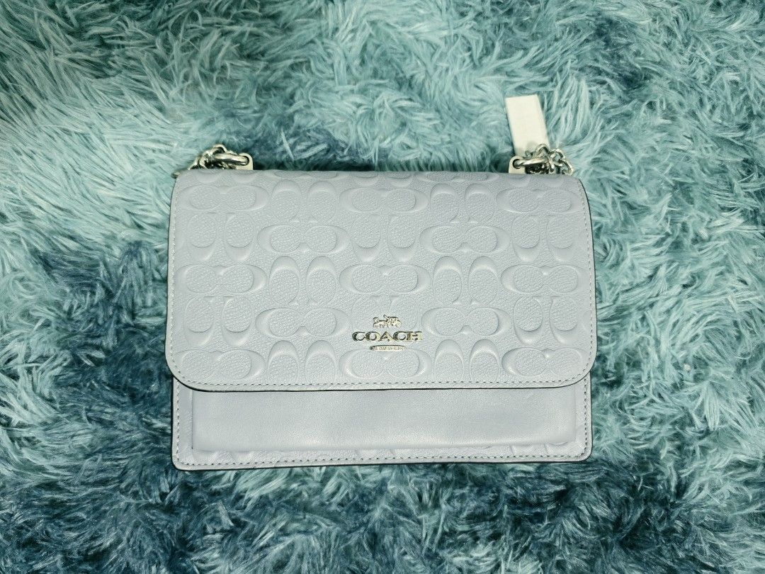 Coach Klare (Category: Cross-body Bags) located in Bacolod City. Submitted by herclosetjoy (Listing ID 1470754178, Image 1). Description: - Authentic light blue Coach crossbody bag - Debossed signature monogram pattern on leather flap - Elegant silver-toned hardware with chain strap - Convenient front slip pocket under the main flap - Clean structure with smooth leather base.