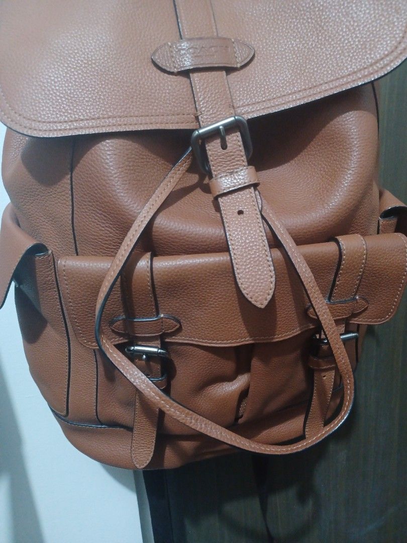 Coach Leather Backpack Tan Brown (Category: Backpacks) located in Mandaluyong City. Submitted by usamenfashionhaul (Listing ID 1470916341, Image 1). Description: - Authentic Coach leather backpack in a stylish tan brown color - Premium pebbled leather texture with secure flap closure and buckle straps - Convenient exterior pockets for quick-access items - Breathable mesh back panel and adjustable leather shoulder straps for all-day comfort - Dura