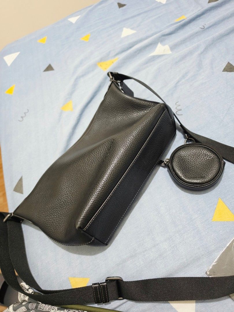 Coach Leather Crossbody Bag Black (Category: Cross-body Bags) located in Makati City. Submitted by lesleylorraine0103 (Listing ID 1470749955, Image 2). Description: - Brand: Coach - Material: Premium textured pebble leather in classic black - Hardware: Elegant gold-tone zippers - Features: Adjustable black strap, exterior zip pocket, and a detachable matching round coin pouch - Interior: Fabric lining with an inner zipper pocket and Coach leather