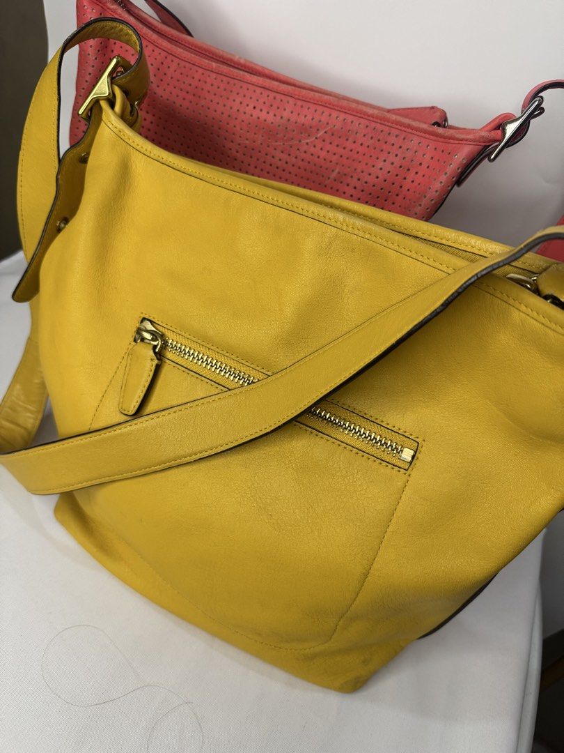 Coach Legacy Duffle Bag BUNDLE (Category: Luxury Bags & Wallets) located in Cagayan de Oro. Submitted by KoaApparelAtbp. (Listing ID 1470799396, Image 3). Description: Coach Legacy Perforated Rugby Stripe Duffle Bag and Coach Legacy Leather Duffle yellow. Has sign of wears in the corner. .