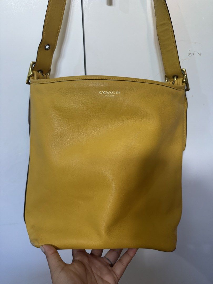 Coach legacy yellow (Category: Luxury Bags & Wallets) located in Cagayan de Oro. Submitted by KoaApparelAtbp. (Listing ID 1470805119, Image 2). Description: Individual detail of coach yellow duffle legacy bag. Clean. .