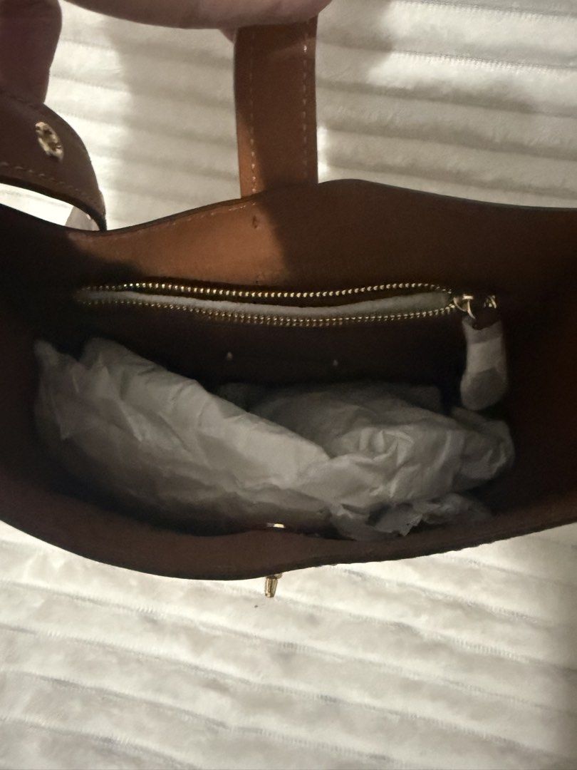 Coach Mini Hadley Bag (Category: Luxury Bags & Wallets) located in Las Pinas. Submitted by purse.vanity (Listing ID 1470832672, Image 3). Description: - Brand: Coach - Style: Leather bucket bag - Color: Rich saddle brown with gold-tone hardware - Condition: Brand new with tags still attached - Features: Structured shape, signature metal logo, and center turn-lock strap closure - Interior: Fabric lining with an inside zip pocket Adjustable strap c