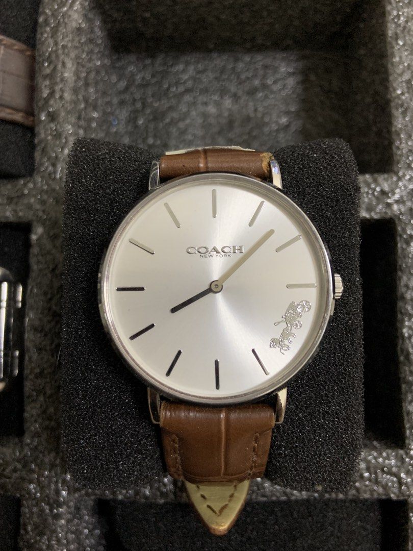 Coach New York Watch with Brown Leather Strap (Category: Women's Watches) located in Manila. Submitted by relokado (Listing ID 1470860430, Image 1). Description: - Brand: Coach dress watch - Dial: Silver sunburst dial with minimalist stick hour markers and signature carriage logo at 4 o'clock - Case: Silver-tone round case - Strap: Genuine brown leather with alligator embossing and standard pin buckle closure - Movement: Quartz movement, battery-