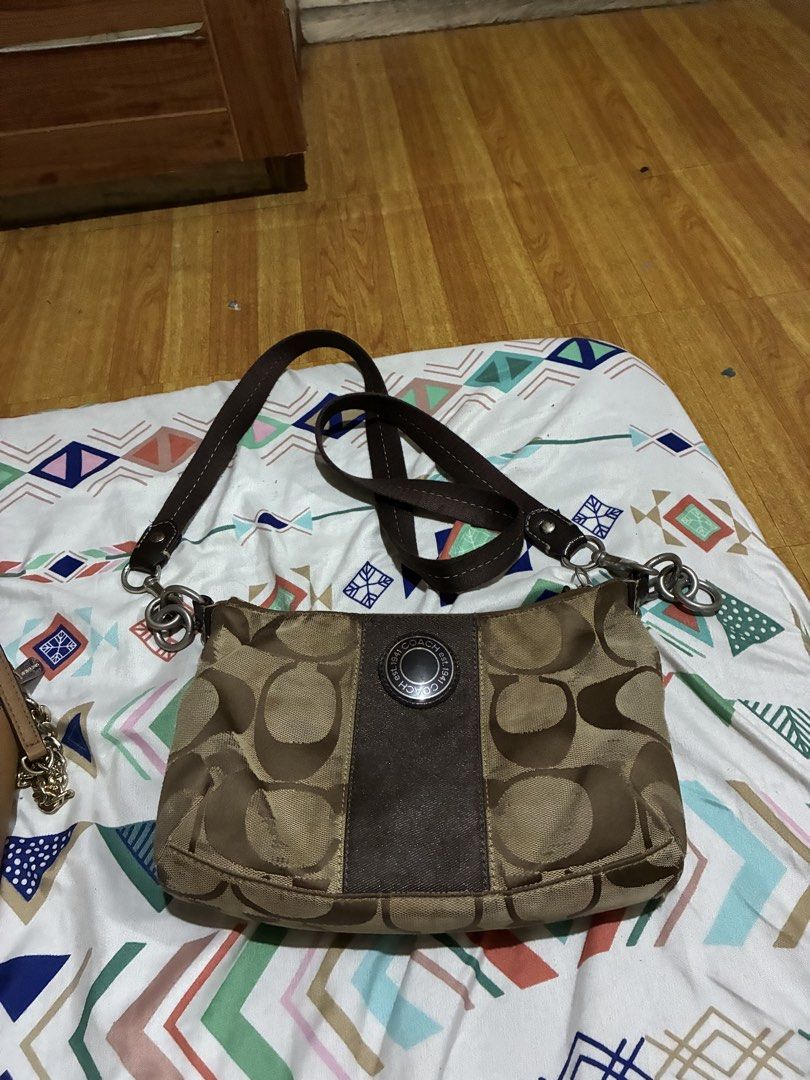 Coach Signature C Brown Canvas Shoulder Bag (Category: Luxury Bags & Wallets) located in Navotas City. Submitted by corazonfar86465 (Listing ID 1470857567, Image 1). Description: - Authentic brown Coach shoulder bag with signature C monogram canvas - Features a stylish dark brown center stripe and comfortable leather strap - Silver-tone hardware accents on the sides - Secure top zipper closure - Fabric-lined interior with good space for daily ess