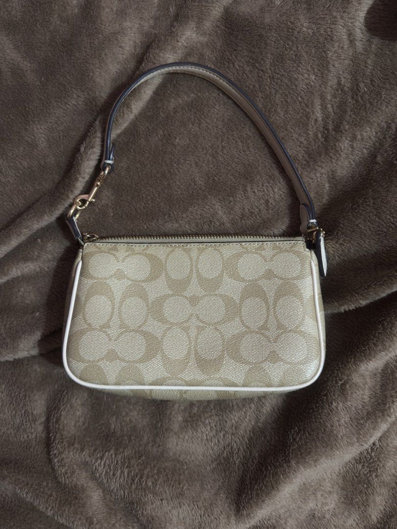 Coach Signature Canvas Mini Bag Beige White (Category: Luxury Bags & Wallets) located in Manila. Submitted by lexxi.00 (Listing ID 1470878447, Image 2). Description: - Authentic Coach mini shoulder bag in signature beige coated canvas - Chic white leather piping and polished gold-tone hardware - Secure zipper top closure with a fabric-lined interior and built-in card slots - Includes a versatile detachable strap and matching leather hangtag - Com