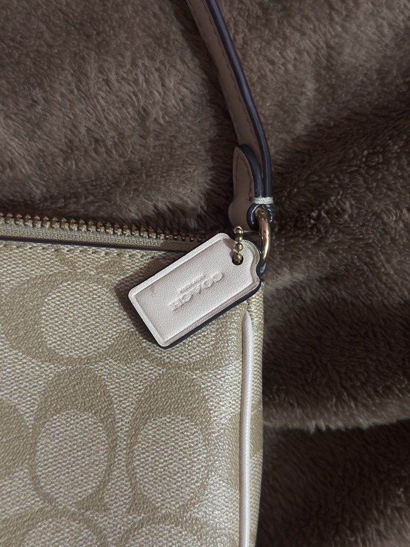 Coach Signature Canvas Mini Bag Beige White (Category: Luxury Bags & Wallets) located in Manila. Submitted by lexxi.00 (Listing ID 1470878447, Image 3). Description: - Authentic Coach mini shoulder bag in signature beige coated canvas - Chic white leather piping and polished gold-tone hardware - Secure zipper top closure with a fabric-lined interior and built-in card slots - Includes a versatile detachable strap and matching leather hangtag - Com