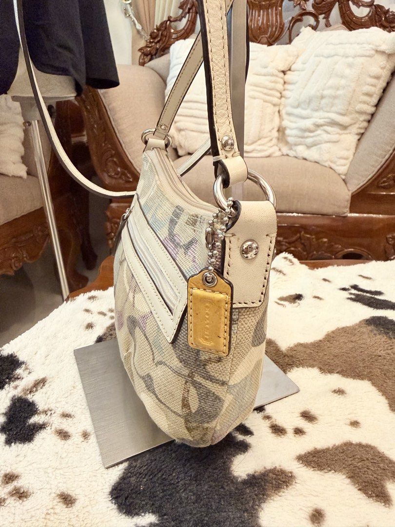 Coach Signature Multi-Color Canvas Shoulder Bag (Category: Cross-body Bags) located in Santiago. Submitted by yrellagnoihsaf (Listing ID 1470772494, Image 2). Description: - Authentic Coach signature canvas shoulder bag - Multi-color pastel C pattern with elegant cream leather trim - Top zip closure and front zip pocket with pull tab - Silver-tone hardware and matching leather hangtag - Light purple satin interior lining with an additional zip po