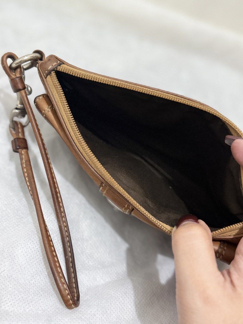 Coach Soho Wristlet (Category: Luxury Bags & Wallets) located in Cainta. Submitted by angellyy_ (Listing ID 1470877018, Image 3). Description: Coach Soho Wristlet Choco brown Condition 7/10 Flaws - Leather oxidation & dryness Water and pen mark at the back Hardware needs polishing .