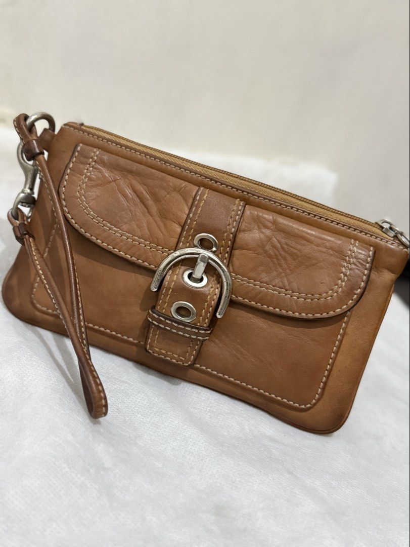 Coach Soho Wristlet (Category: Luxury Bags & Wallets) located in Cainta. Submitted by angellyy_ (Listing ID 1470877018, Image 1). Description: Coach Soho Wristlet Choco brown Condition 7/10 Flaws - Leather oxidation & dryness Water and pen mark at the back Hardware needs polishing .