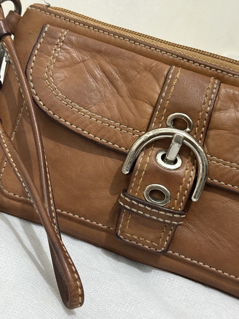 Coach Soho Wristlet (Category: Luxury Bags & Wallets) located in Cainta. Submitted by angellyy_ (Listing ID 1470877018, Image 2). Description: Coach Soho Wristlet Choco brown Condition 7/10 Flaws - Leather oxidation & dryness Water and pen mark at the back Hardware needs polishing .