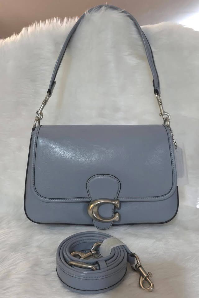 Coach Tabby Shoulder Bag Light Blue Leather (Category: Shoulder Bags) located in Manila. Submitted by michee08 (Listing ID 1470801009, Image 1). Description: Coach shoulder bag in light blue leather. Signature C hardware in silver tone. Includes top handle plus a detachable long strap, rolled up at the bottom. Tag still attached to the side. Clean structured shape with dark edge glazing..