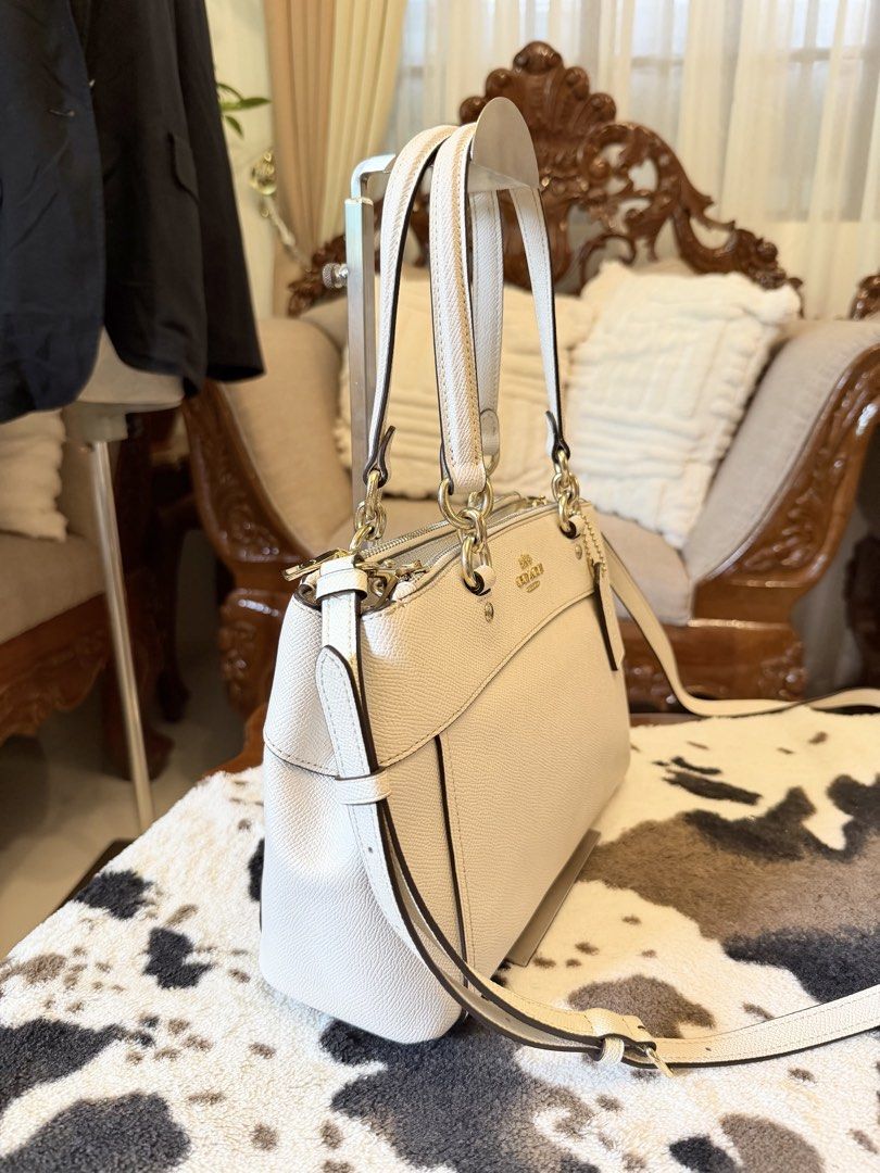 Coach White Leather Satchel Crossbody Bag (Category: Cross-body Bags) located in Santiago. Submitted by yrellagnoihsaf (Listing ID 1470795168, Image 3). Description: Authentic Coach white handbag Brooke Carryall in the chalk colorway made from textured crossgrain leather almost new normal signs of wear onlee konting fading sa hardware rubber lining intact no peeling kasya long wallet at promax onting anik 💋💋💋.