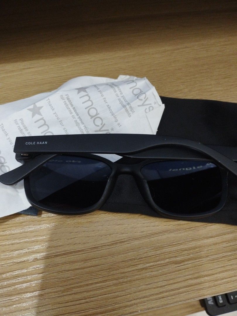 Cole Haan Polarized Matte Black Sunglasses (Category: Sunglasses & Eyewear) located in Caloocan City. Submitted by shopaholic_cousins (Listing ID 1470877187, Image 2). Description: - Brand: Cole Haan - Model: CH6033 - Color: Matte Black with dark tinted polarized lenses - Size: Lens 53, Bridge 17, Temple 145 - Manufacture Date: 05/23 - Inclusions: Black storage pouch and Macy's store receipt wrapper - Design: Classic square frame with minimalist 
