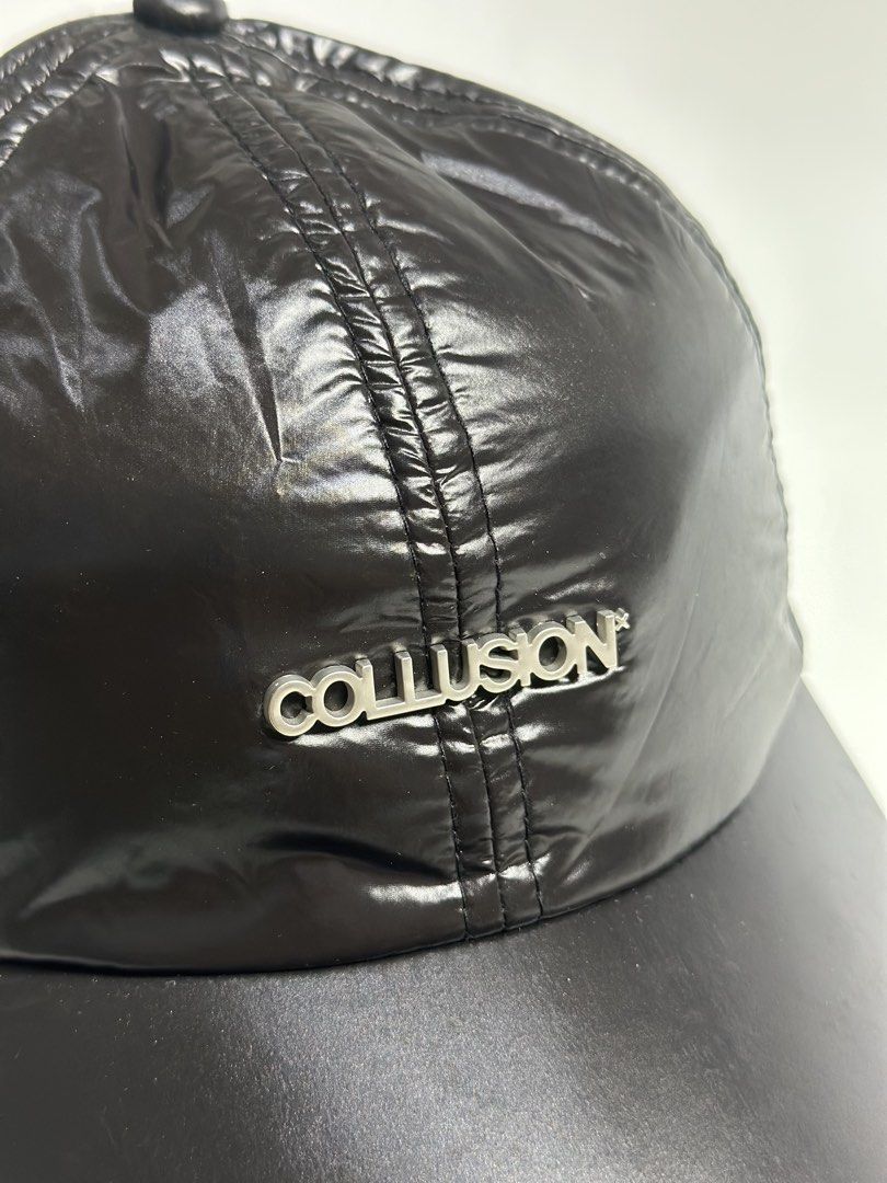 Collusion black nylon shiny baseball cap with silver hardware (Category: Caps & Hats) located in Daet. Submitted by thrifthings2018 (Listing ID 1470844943, Image 2). Description: - Brand: Collusion - Material: Lightweight shiny nylon with matte black brim - Design: Metal logo plate on front crown and structured stitched panel construction - Fit: Adjustable back strap with silver metal buckle - Condition: Clean and ready to wear.