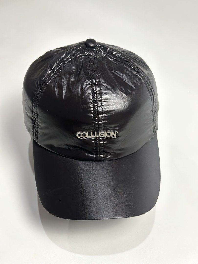 Collusion black nylon shiny baseball cap with silver hardware (Category: Caps & Hats) located in Daet. Submitted by thrifthings2018 (Listing ID 1470844943, Image 1). Description: - Brand: Collusion - Material: Lightweight shiny nylon with matte black brim - Design: Metal logo plate on front crown and structured stitched panel construction - Fit: Adjustable back strap with silver metal buckle - Condition: Clean and ready to wear.
