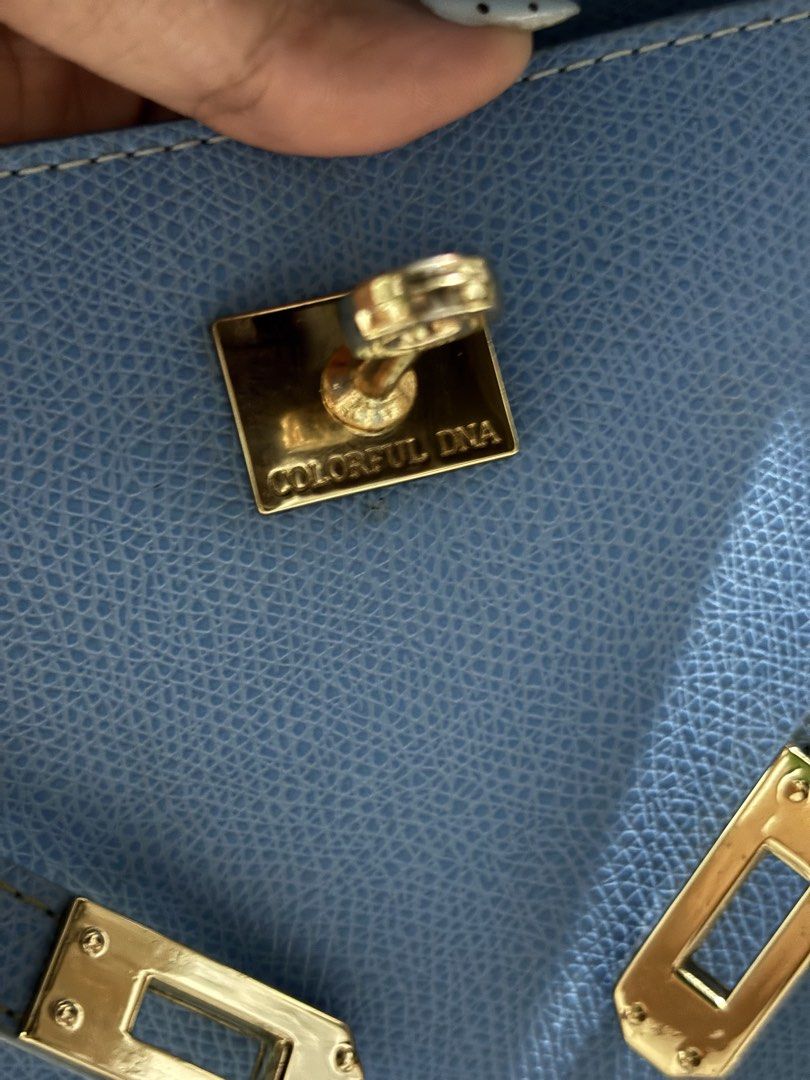 Colorful Dna Blue Top Handle Handbag With Strap (Category: Shoulder Bags) located in Rizal. Submitted by va_nes_sa_ (Listing ID 1470821558, Image 2). Description: - Brand: Colorful Dna (Kelly inspired) - Color: Textured blue with gold hardware - Closure: Turn-lock - Inclusions: Matching strap, attached padlock, and clochette - Interior: One main compartment with a small side pocket - Details: Clean structure with neat contrast stitching - Conditi