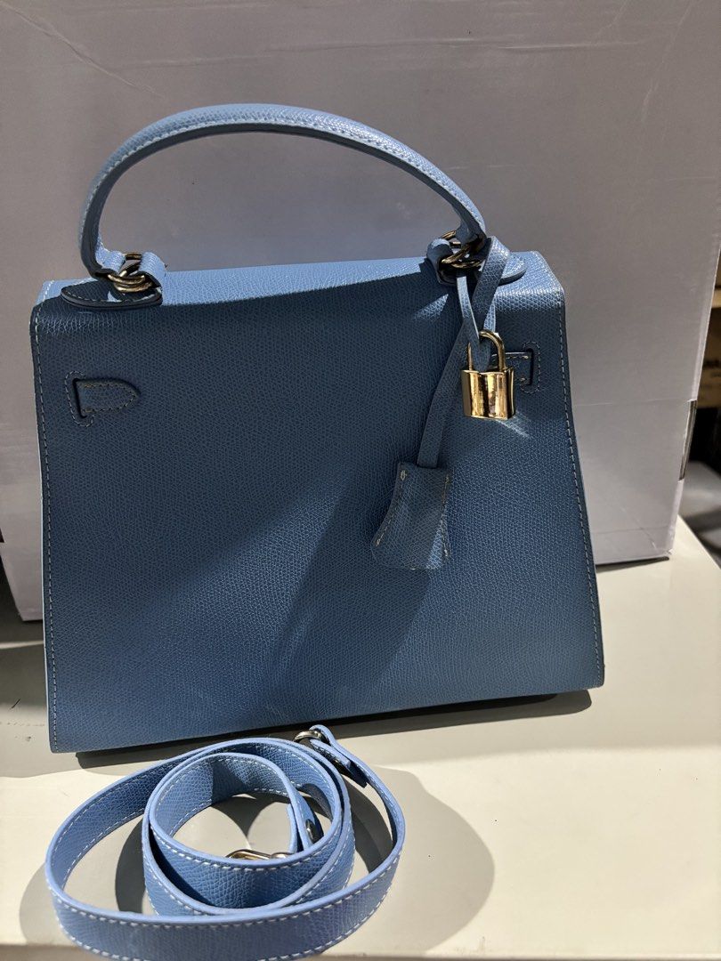 Colorful Dna Blue Top Handle Handbag With Strap (Category: Shoulder Bags) located in Rizal. Submitted by va_nes_sa_ (Listing ID 1470821558, Image 3). Description: - Brand: Colorful Dna (Kelly inspired) - Color: Textured blue with gold hardware - Closure: Turn-lock - Inclusions: Matching strap, attached padlock, and clochette - Interior: One main compartment with a small side pocket - Details: Clean structure with neat contrast stitching - Conditi