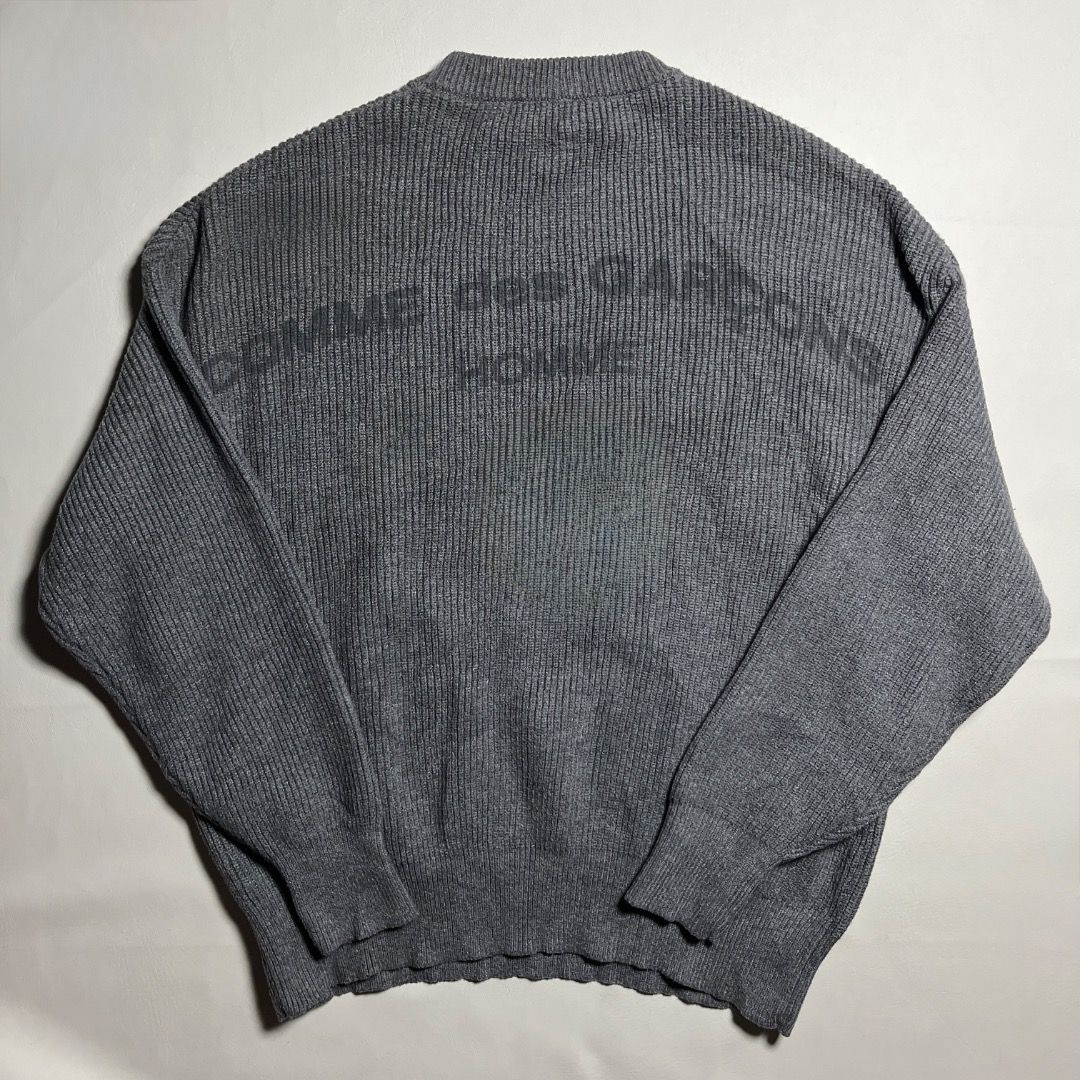 Comme des Garcoms Grey Knit Long Sleeve Sweater (Category: Longsleeves) located in Caloocan City. Submitted by achilles_grails (Listing ID 1470834671, Image 2). Description: - Color: Grey - Style: Classic crew neckline with textured waffle knit pattern - Fit: Relaxed fit through arms and torso for maximum comfort - Details: Ribbed cuffs and hem - Material: Warm knit fabric, ideal for cooler weather - Condition: Clean collar label intact.