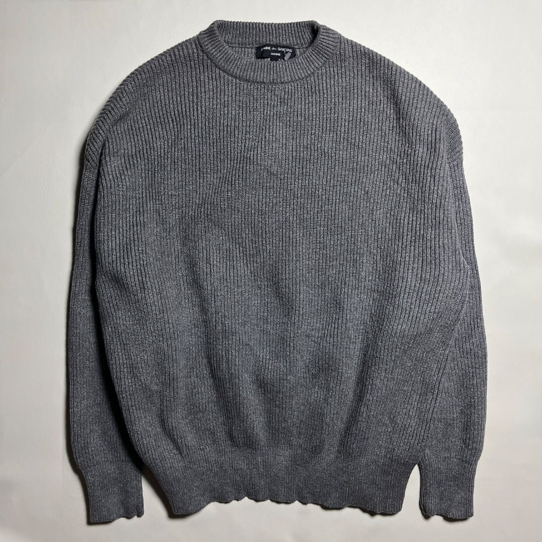 Comme des Garcoms Grey Knit Long Sleeve Sweater (Category: Longsleeves) located in Caloocan City. Submitted by achilles_grails (Listing ID 1470834671, Image 1). Description: - Color: Grey - Style: Classic crew neckline with textured waffle knit pattern - Fit: Relaxed fit through arms and torso for maximum comfort - Details: Ribbed cuffs and hem - Material: Warm knit fabric, ideal for cooler weather - Condition: Clean collar label intact.