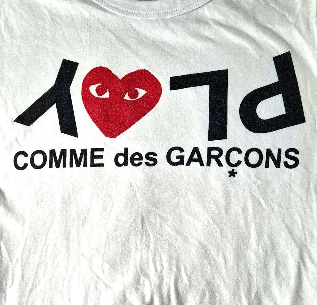 Comme des Garçons PLAY Inverted Text T-shirt (Category: Shirts) located in Antipolo. Submitted by saribymonica (Listing ID 1470866650, Image 2). Description: Size: small ✨ PLEASE READ BEFORE PURCHASING ✨ • Items have been stored in the cabinet and may be wrinkled or need ironing. • Colors may vary slightly due to lighting and screen settings. • Please check all photos carefully before purchasing. • Any visible flaws noticed during inspection will