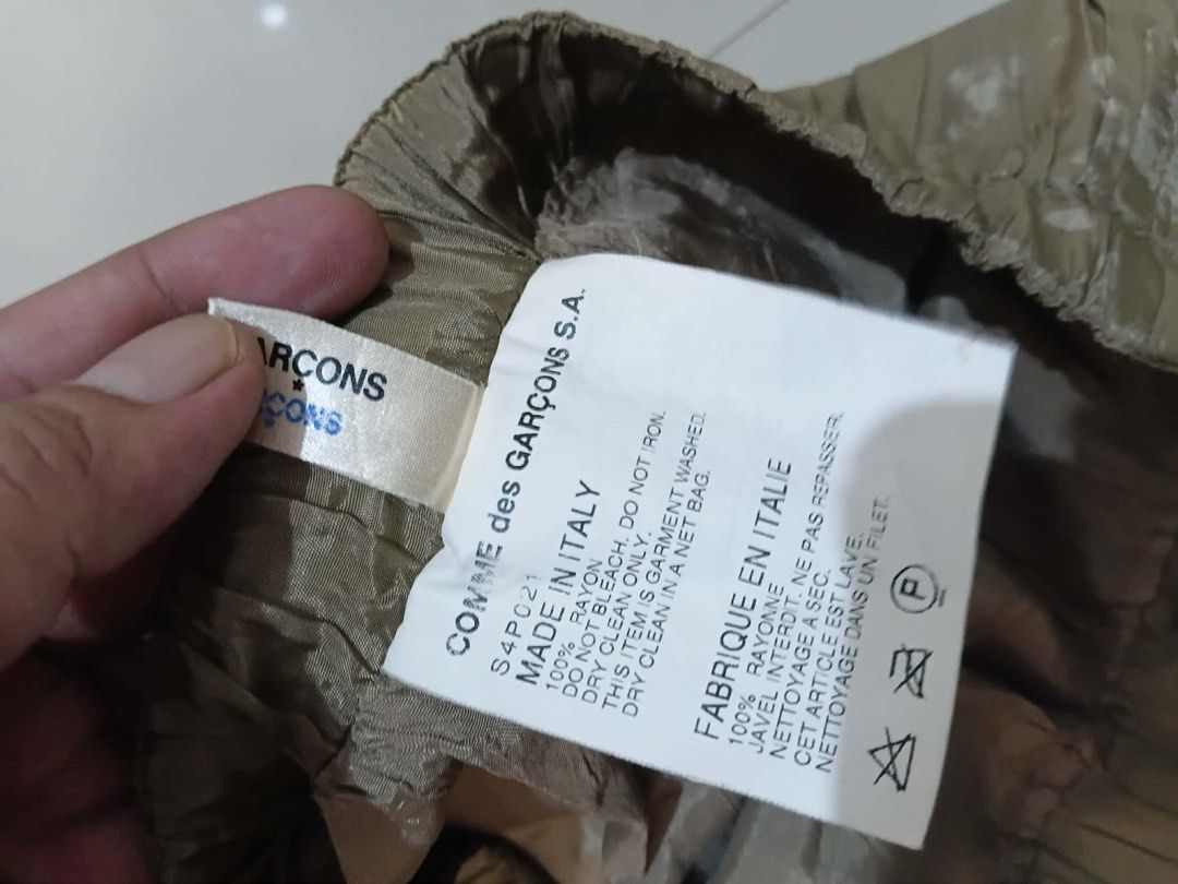 COMME des GARÇONS S4P021 Rayon Cropped Pants (Category: Trousers) located in Manila. Submitted by kuya_erick62 (Listing ID 1470759907, Image 2). Description: - Brand: COMME des GARÇONS - Color: Taupe - Size: Cropped fit - Material: 100% Rayon, Made in Italy - Features: Elastic waistband, gathered cuffs, lightweight feel, and stylish crumpled texture finish - Care: Dry clean only in a net bag - Condition: Excellent, ready to wear.