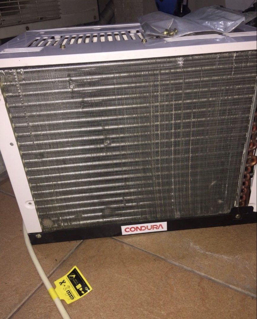 Condura 6S Window Type Air Conditioner WCONZ006EC (Category: Air Conditioning and Heating) located in Muntinlupa City. Submitted by cynthiacarriscanindo (Listing ID 1470859073, Image 3). Description: - Brand: Condura Window Type Aircon - Model: WCONZ006EC (0.5 HP conventional) - Controls: Easy manual knobs for thermostat, fan speed, and timer - Design: White plastic casing with classic horizontal grill - Efficiency: Includes energy savings plug w
