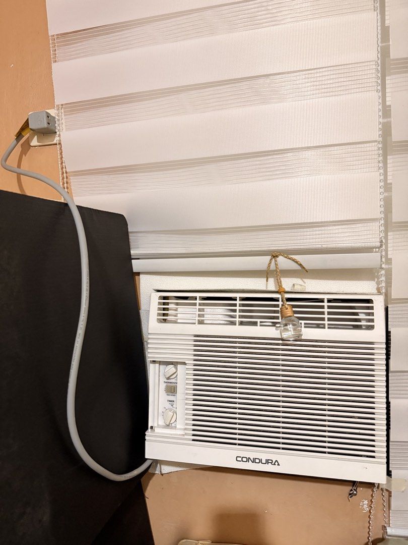 Condura 6S Window Type Air Conditioner WCONZ006EC (Category: Air Conditioning and Heating) located in Muntinlupa City. Submitted by cynthiacarriscanindo (Listing ID 1470859073, Image 2). Description: - Brand: Condura Window Type Aircon - Model: WCONZ006EC (0.5 HP conventional) - Controls: Easy manual knobs for thermostat, fan speed, and timer - Design: White plastic casing with classic horizontal grill - Efficiency: Includes energy savings plug w