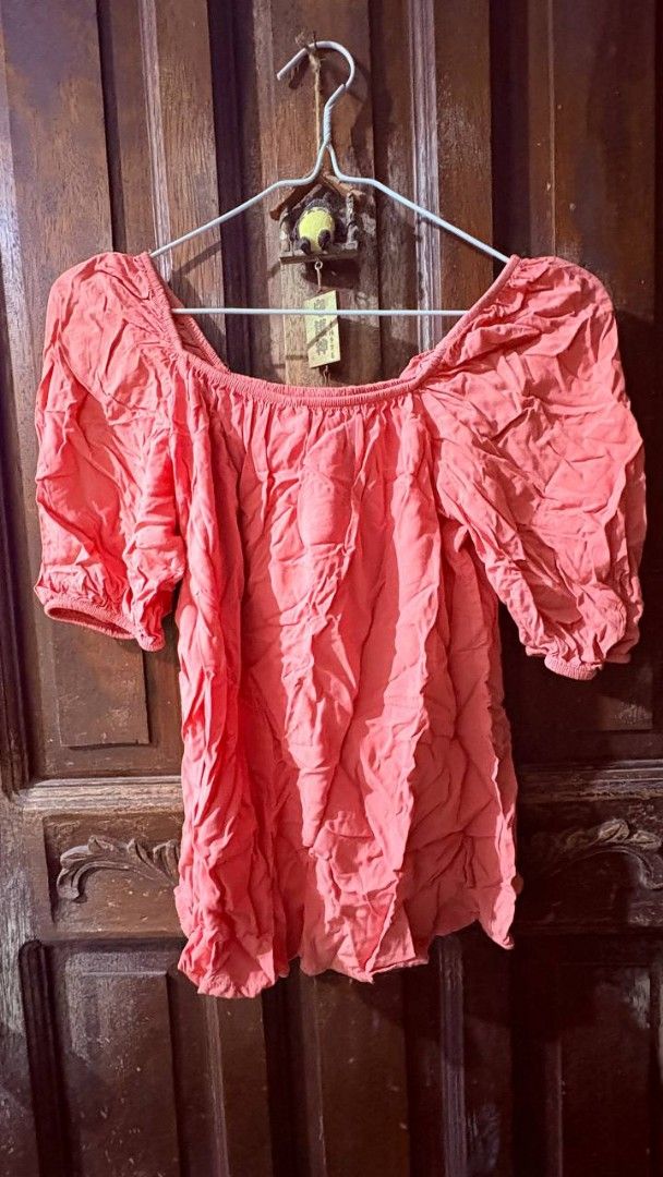Coral Off-Shoulder Puff Sleeve Blouse (Category: Blouses) located in Manila. Submitted by jaysieseva620 (Listing ID 1470829596, Image 1). Description: - Color: Coral pink - Style: Off-shoulder with short puff sleeves - Fit: Relaxed fit, elastic neckline and cuffs for comfort - Fabric: Lightweight and breathable for warm weather - Condition: Brand new/good, has minor storage wrinkles and needs a quick iron - Easy to match with jeans or skirts!.