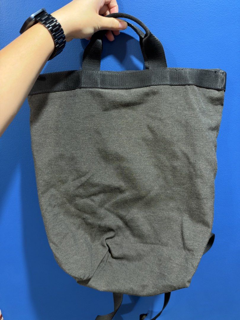 COS grey-and-black tote-backpack (Category: Backpacks) located in Manila. Submitted by garagesalebykoda (Listing ID 1470816388, Image 2). Description: - Brand: COS - Color: Dark Grey - Material: Sturdy canvas with durable webbing details - Convertible design: Easily switches between a tote bag and a backpack - Straps: Adjustable shoulder straps and dual top carry handles - Closure: Secure zip top closure - Interior features: COS branded leather p