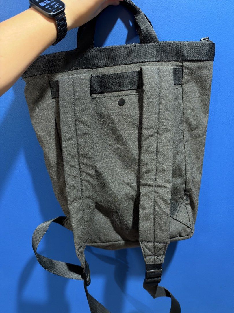 COS grey-and-black tote-backpack (Category: Backpacks) located in Manila. Submitted by garagesalebykoda (Listing ID 1470816388, Image 1). Description: - Brand: COS - Color: Dark Grey - Material: Sturdy canvas with durable webbing details - Convertible design: Easily switches between a tote bag and a backpack - Straps: Adjustable shoulder straps and dual top carry handles - Closure: Secure zip top closure - Interior features: COS branded leather p