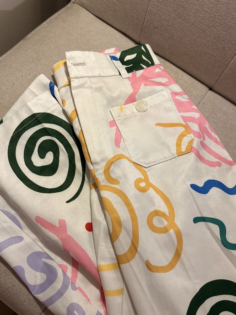 Cotton Candy Abstract Print Pants Size M (Category: Jeans) located in Pasig City. Submitted by shitaku.ph (Listing ID 1470856707, Image 1). Description: - Brand: Cotton Candy - Size: M (tag attached) - Color: White with multicolored abstract print (pink, green, yellow, blue swiggles and geometric shapes) - Features: Back pockets with white buttons, belt loops, zip fly with button closure - Condition: Brand new with tags.