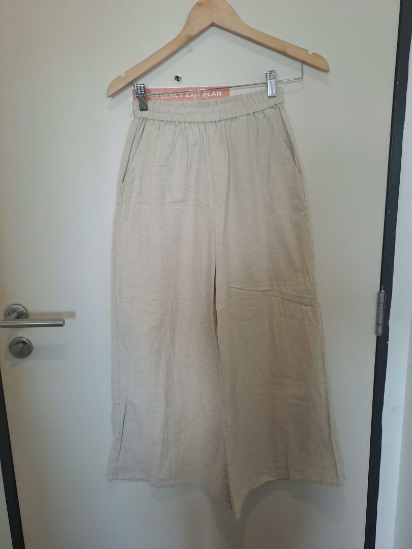 cotton linen wide leg (Category: Other Bottoms) located in Mandaluyong City. Submitted by epicowl-c93c (Listing ID 1470786434, Image 1). Description: These trousers feature a classic, comfortable design perfect for warm weather or relaxed everyday wear. Key Design Features Silhouette: Wide-leg, relaxed fit with a cropped or ankle-length hemline. Waistband: High-rise fit characterized by a prominent gathered elastic waistband for easy pull-on comf