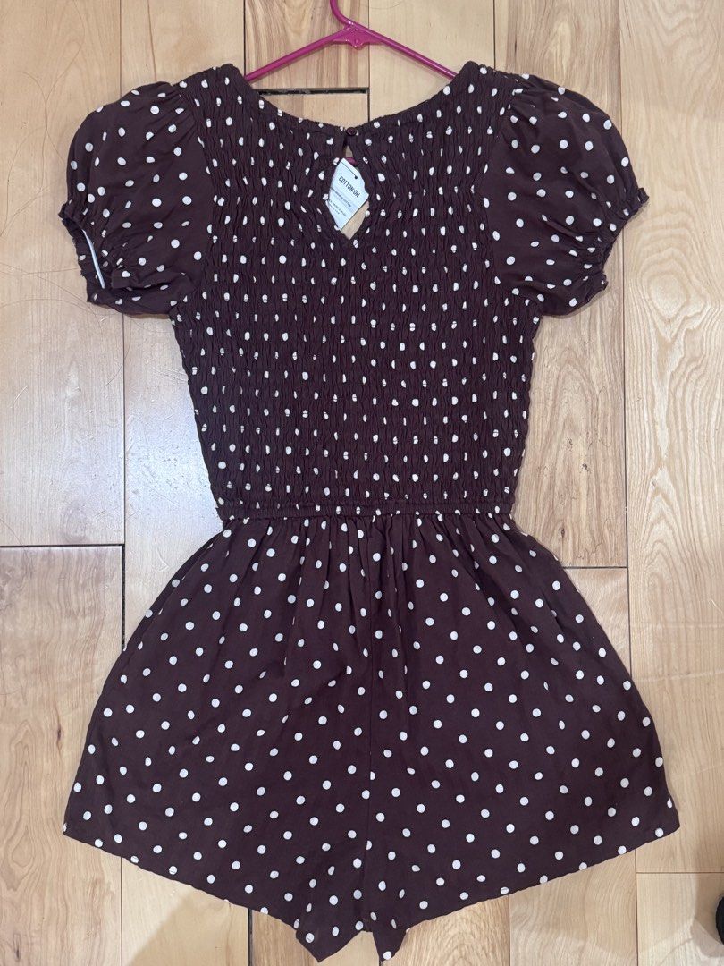 Cotton On Polka dot romper chocolate brown (Category: Rompers) located in Abucay. Submitted by a.lovescloset (Listing ID 1470850777, Image 3). Description: - Brand: Cotton On - Brand new with tags (BNWT) - Brown with white polka dots - Design: Smocked bodice, puff sleeves with elastic cuffs, front tie detail, and keyhole cutout - Material: Lightweight and breathable - Size: Standard fit.