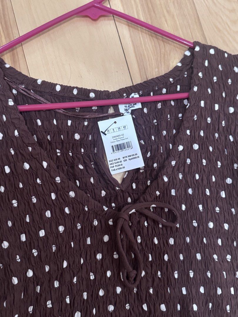 Cotton On Polka dot romper chocolate brown (Category: Rompers) located in Abucay. Submitted by a.lovescloset (Listing ID 1470850777, Image 2). Description: - Brand: Cotton On - Brand new with tags (BNWT) - Brown with white polka dots - Design: Smocked bodice, puff sleeves with elastic cuffs, front tie detail, and keyhole cutout - Material: Lightweight and breathable - Size: Standard fit.