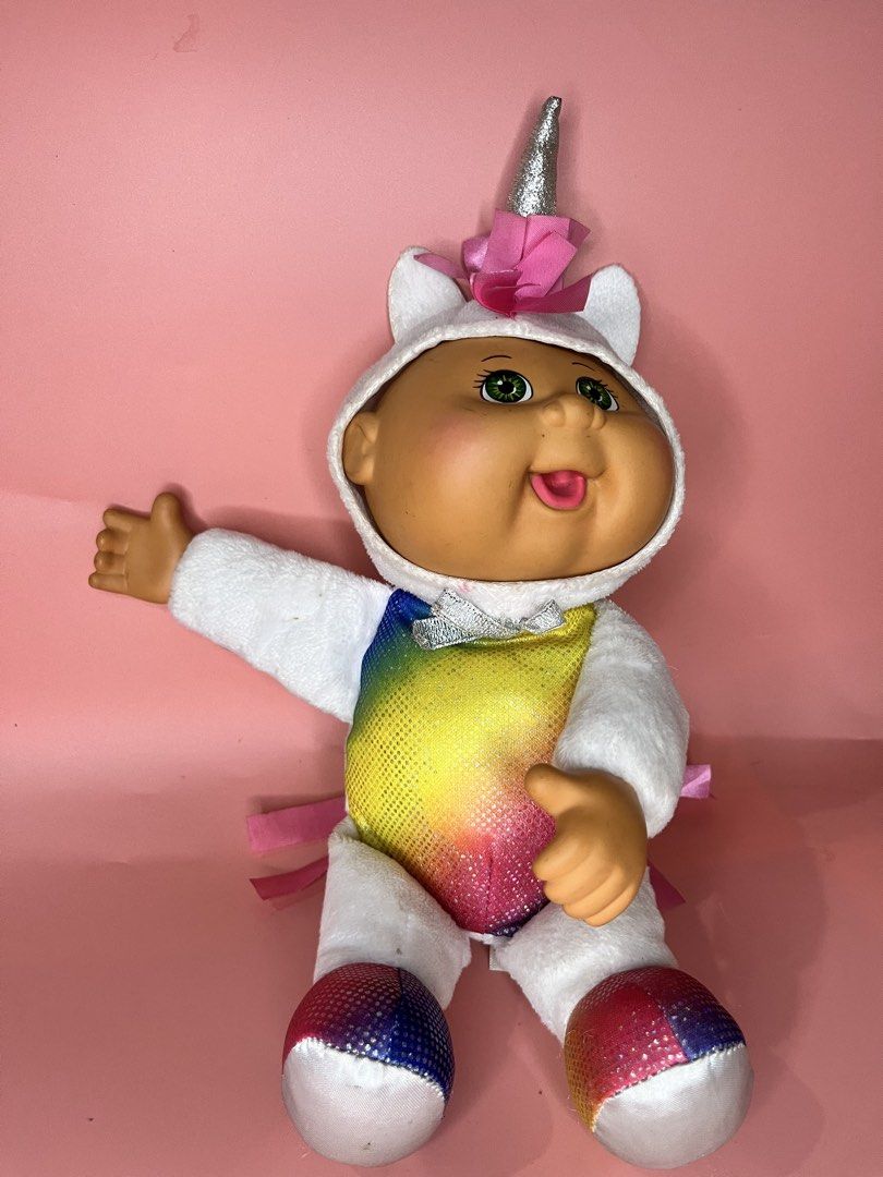 CPK Cabbage Patch Kids Unicorn Plush Doll (Category: Plushies & Soft Toys) located in Caloocan City. Submitted by snapshop_ph (Listing ID 1470818608, Image 1). Description: - Authentic Cabbage Patch Kids unicorn plush toy with original CPK fabric tag - Features a sparkly silver horn and bright green eyes - Colorful rainbow glitter belly with pink ribbon mane and tail - White plush body with glittery multicolored hooves - Super soft, clean overall